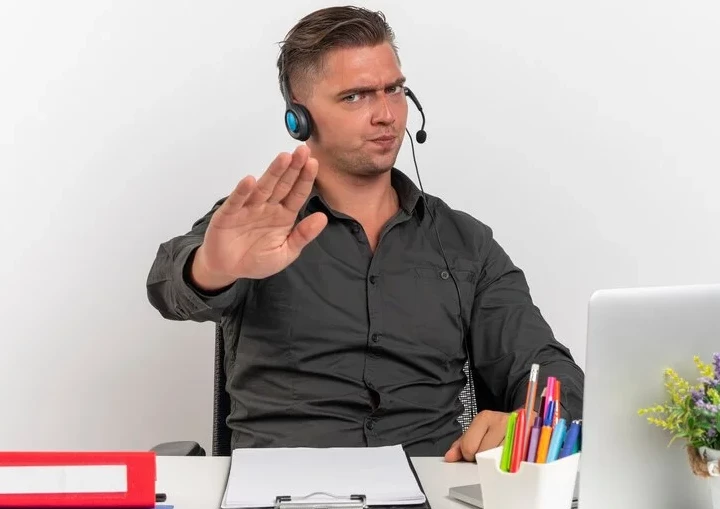 An employee saying no with hand gesture